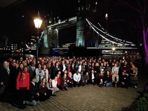 Attendees of the IVVN 2019 conference standing in front of London's Tower Bridge at night