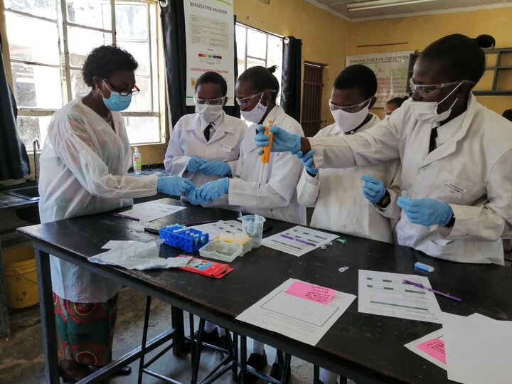 Students in a classroom learning how to use micro pipettes