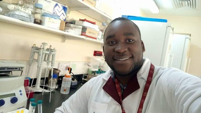 Amos Lucky Mhone selfie taken in a laboratory