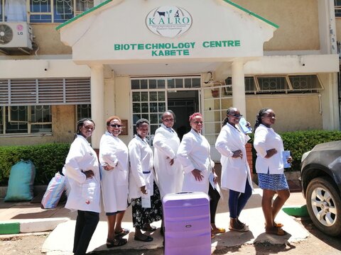 The outreach team with their mobile lab-in-a-suitcase. From left to right: Perpetua Wangari, Esther Kanduma, Grace Gacheri, Susan Kabacia, Janet Kariuki, Celestine Makokha, Esese Tuila Esese.