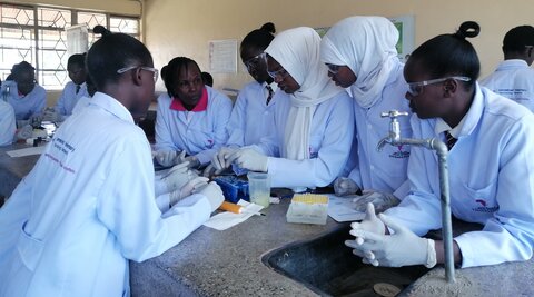 Students of Embakasi Girls High School conducting a rabies vaccination experiment.